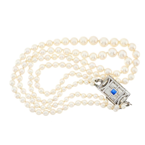 149 - A cultured pearl two-row necklace, with Art Deco sapphire and vari-cut diamond clasp, estimated tota... 