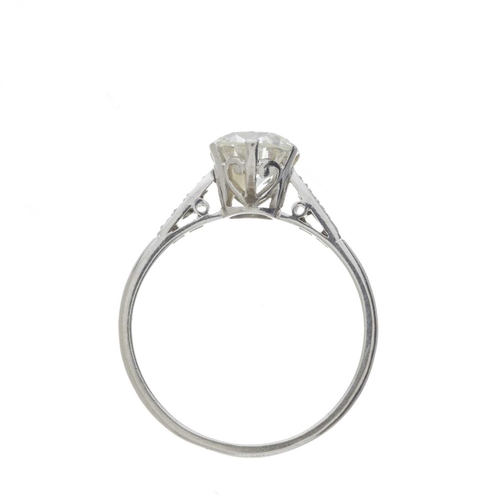 156 - An Art Deco platinum transitional-cut diamond single-stone ring, with diamond shoulders, principal d... 