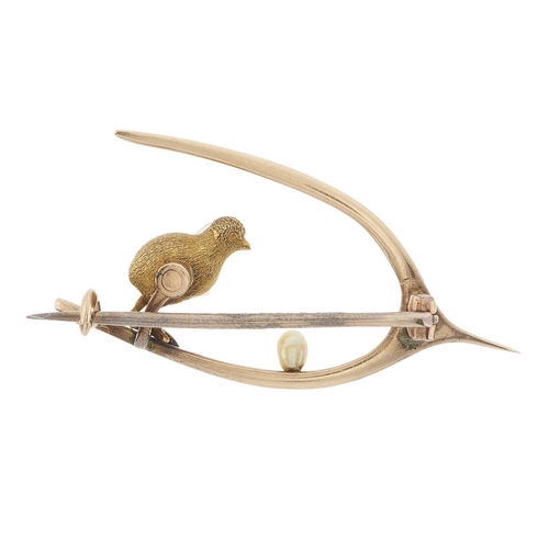 16 - An early 20th century gold wishbone brooch, modelled as a chick and a seed pearl egg, length 3.5cm, ... 