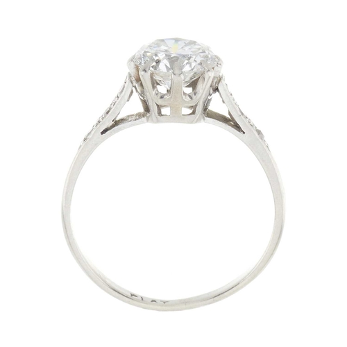 166 - A mid 20th century platinum circular-cut diamond single-stone ring, with old-cut diamond line should... 