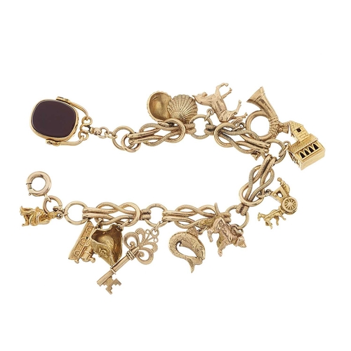 175 - A fancy-link charm bracelet, suspending a series of eleven charms, including a church stanhope charm... 