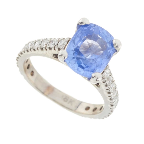 192 - An 18ct gold Sri Lankan sapphire single-stone dress ring, with brilliant-cut diamond line shoulders,... 