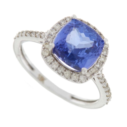 204 - An 18ct gold tanzanite and brilliant-cut diamond cluster ring, with similarly-cut diamond line shoul... 