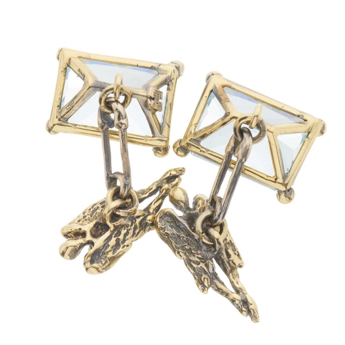 218 - A pair of 18ct gold novelty cufflinks, each designed as a rectangular-shape aquamarine and a stylise... 