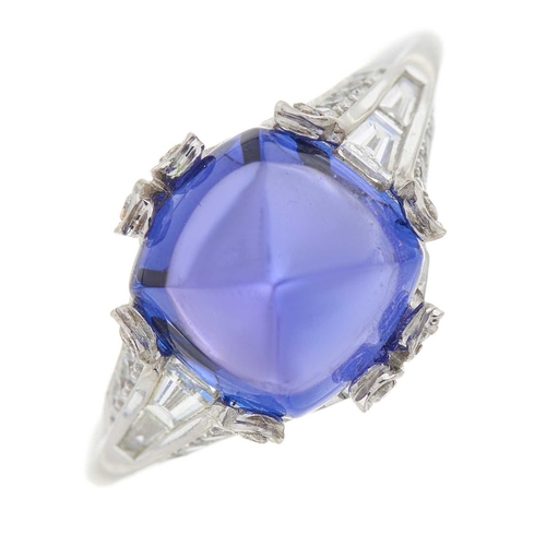 234 - An 18ct gold sugarloaf tanzanite cabochon dress ring, with calibre-cut diamond sides and brilliant-c... 