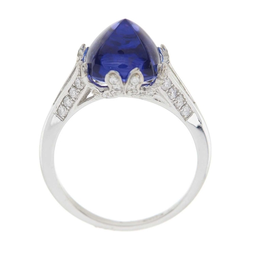 234 - An 18ct gold sugarloaf tanzanite cabochon dress ring, with calibre-cut diamond sides and brilliant-c... 