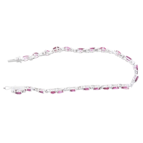 251 - A platinum ruby and brilliant-cut diamond line bracelet, with push-piece clasp, total ruby weight 6.... 