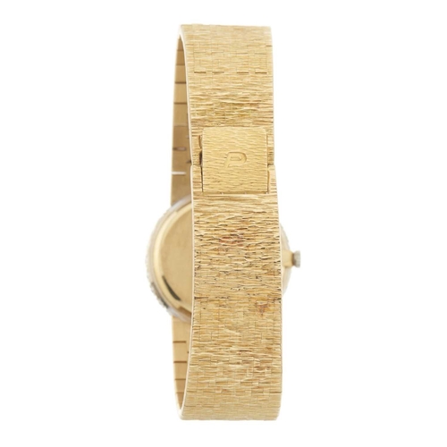 309 - 
Piaget
A diamond set bracelet watch with tiger's eye dial
Case: Signed. 18ct gold. Swiss convention... 