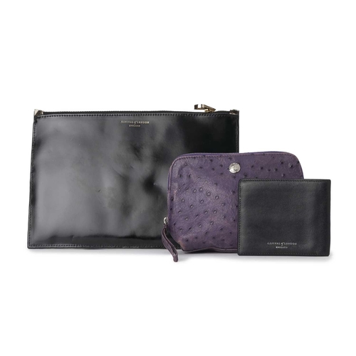 343 - Aspinal of London, a wallet and two pouches, to include a smooth black leather bi-fold wallet openin... 