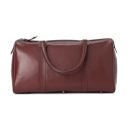 352 - Cartier, a large Bordeaux Must De Cartier Boston travel bag, crafted from burgundy leather, with gol... 