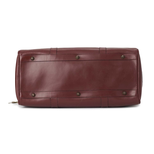 352 - Cartier, a large Bordeaux Must De Cartier Boston travel bag, crafted from burgundy leather, with gol... 