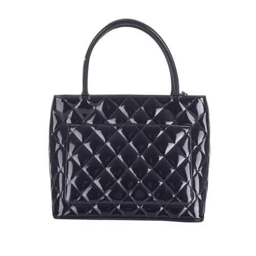 372 - Chanel, a Timeless Medallion tote, crafted from black patent leather with the maker's classic diamon... 