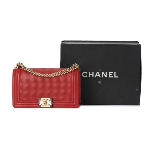 373 - Chanel, a Medium Cube Embossed Boy handbag, crafted from red leather, designed with a cube embossed ... 