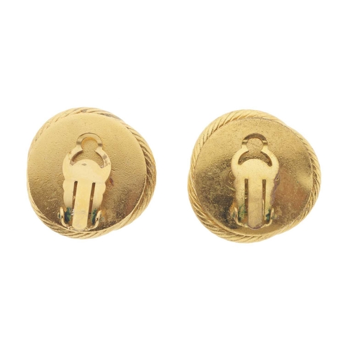 380 - Chanel, a pair of clip-on earrings, featuring an imitation pearl to the centre and a gold-tone twist... 