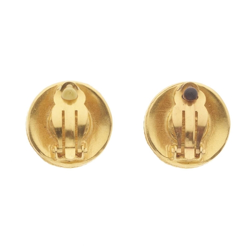 381 - Chanel, a pair of clip-on earrings, featuring an imitation pearl to the centre and a textured gold-t... 