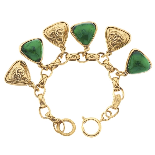 387 - Chanel, a vintage Gripoix charm bracelet, featuring a quilted gold-tone oval-link chain, suspending ... 