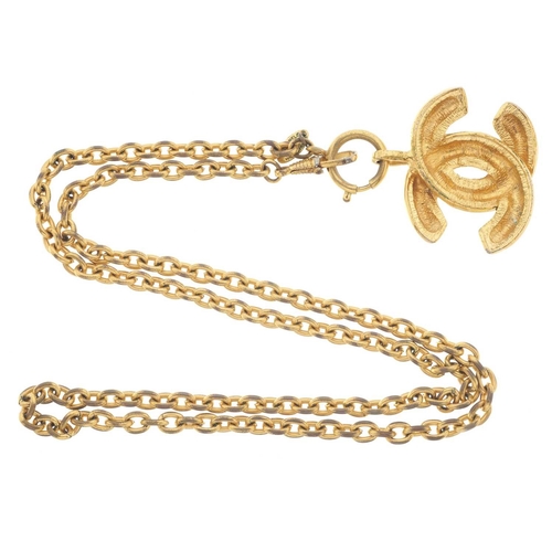 388 - Chanel, a vintage 1980s gold-tone quilted CC pendant, comprising an oval-link chain necklace suspend... 