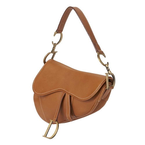 394 - Christian Dior, a leather Saddle handbag, crafted from caramel leather, featuring a flat shoulder st... 