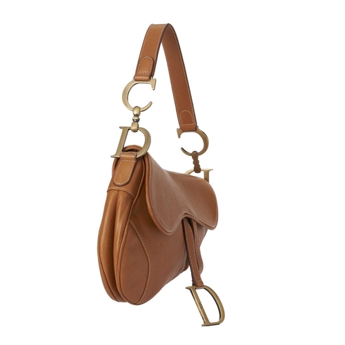 394 - Christian Dior, a leather Saddle handbag, crafted from caramel leather, featuring a flat shoulder st... 