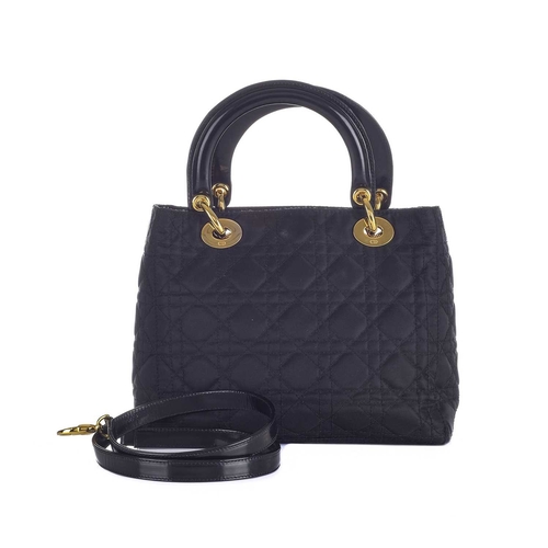 395 - Christian Dior, a black Lady Dior PM handbag, designed with a cannage quilted nylon exterior, with r... 