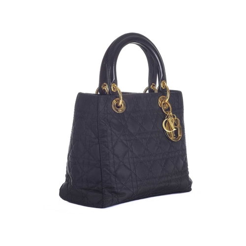 395 - Christian Dior, a black Lady Dior PM handbag, designed with a cannage quilted nylon exterior, with r... 