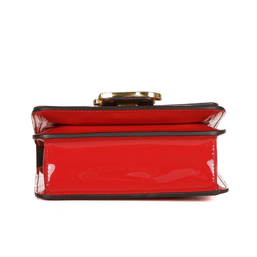 407 - Fendi, a Karligraphy patent leather handbag, designed with a cardinal red patent leather exterior, w... 