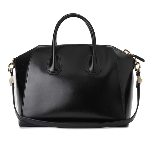 412 - Givenchy, an Antigona handbag, designed with a smooth black leather exterior, with a triangular patc... 