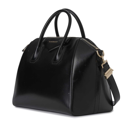 412 - Givenchy, an Antigona handbag, designed with a smooth black leather exterior, with a triangular patc... 