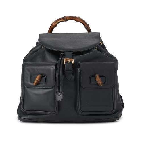 423 - Gucci, a large Bamboo backpack, featuring a smooth navy blue leather exterior, curved bamboo top han... 