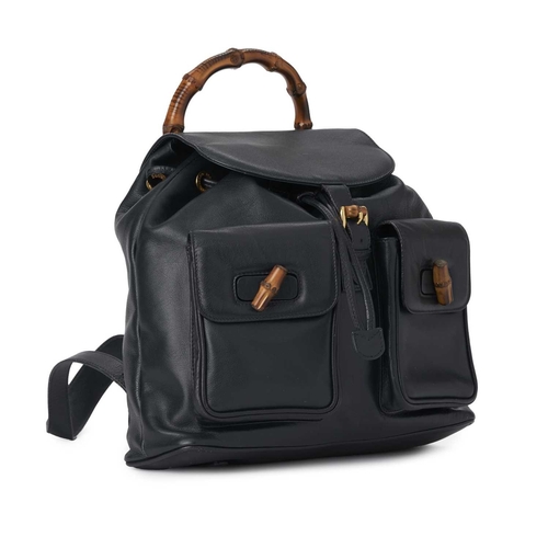 423 - Gucci, a large Bamboo backpack, featuring a smooth navy blue leather exterior, curved bamboo top han... 