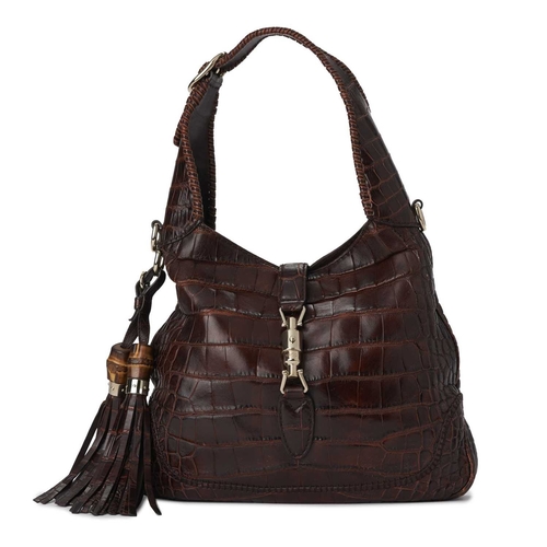 424 - Gucci, a crocodile Jackie shoulder bag, crafted from luxurious brown crocodile skin, featuring gold-... 