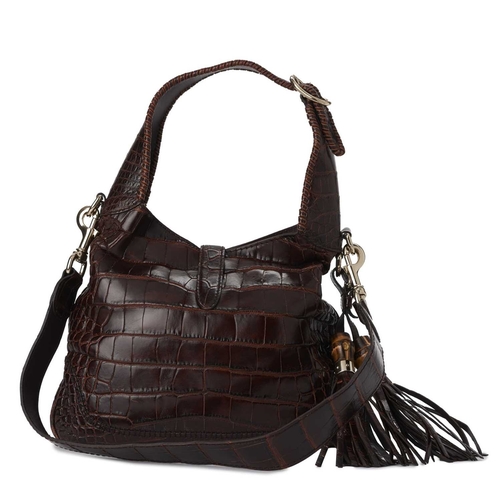 424 - Gucci, a crocodile Jackie shoulder bag, crafted from luxurious brown crocodile skin, featuring gold-... 