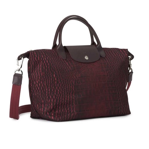 443 - Longchamp, a Le Pliage crossbody handbag, designed with a crocodile printed purple nylon exterior, w... 