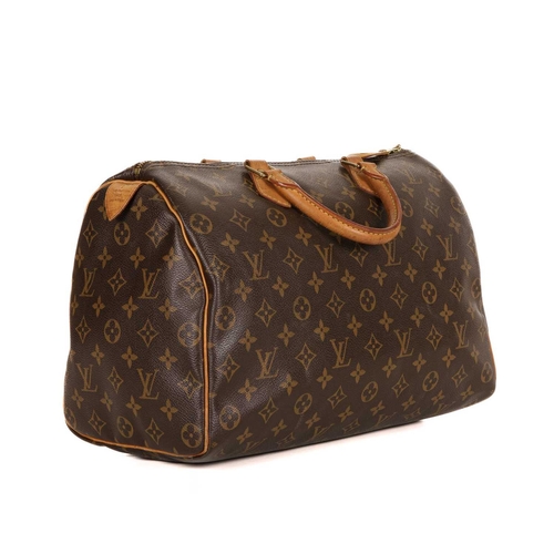 464 - Louis Vuitton, a monogram Speedy 35 handbag, featuring the maker's monogram coated canvas exterior w... 