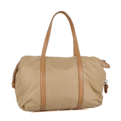 508 - Prada, a nylon tote, designed with a beige nylon exterior, tan leather trim and top handles, front z... 