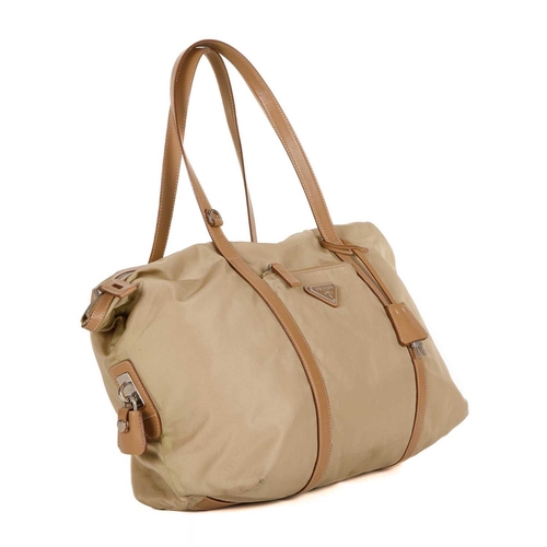 508 - Prada, a nylon tote, designed with a beige nylon exterior, tan leather trim and top handles, front z... 