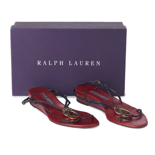 513 - Ralph Lauren, a pair of purple label T-strap sandals, featuring navy blue leather straps, decorative... 