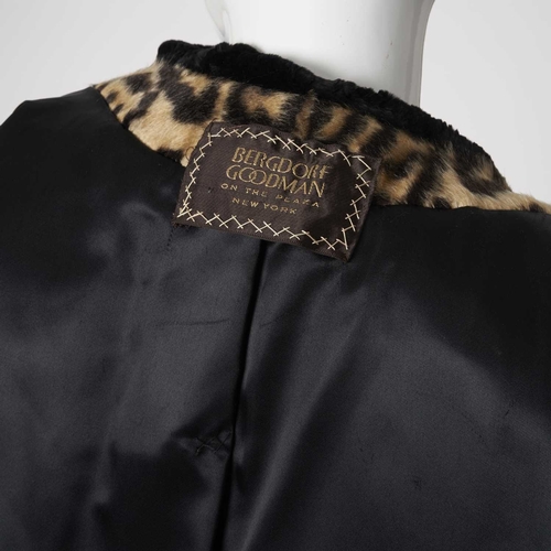 547 - Bergdorf Goodman, a faux fur coat with real seal fur trim, featuring a stencilled leopard patterned ... 