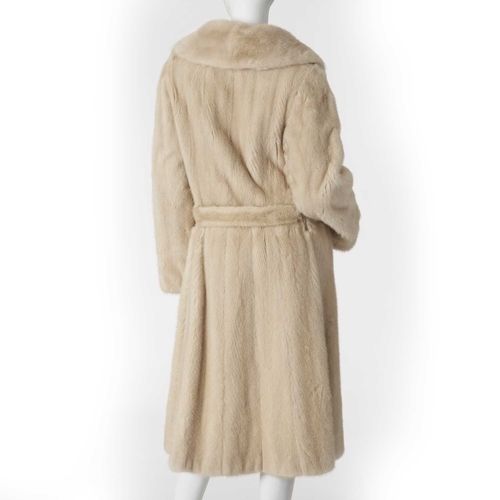 551 - A fitted pearl mink coat, fully stranded, with a large notched lapel collar, hook and eye clip faste... 