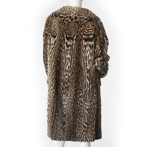 552 - A 1950s ocelot fur coat, featuring a notched lapel collar, six fur-covered front buttons, rolled cuf... 