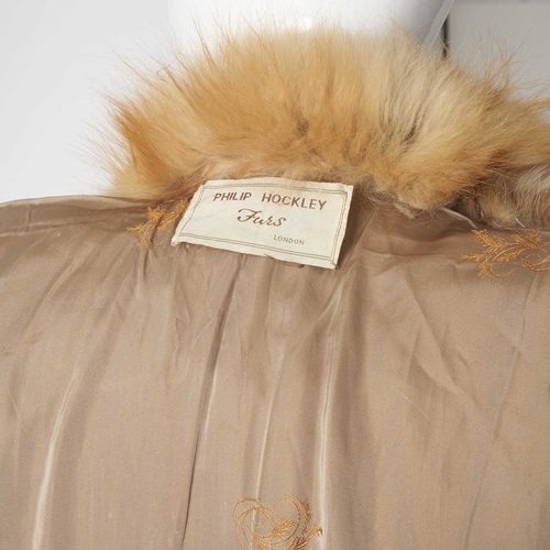 559 - Philip Hockley, a coyote wolf fur coat, designed with red fox fur trim, hook and eye fastenings and ... 