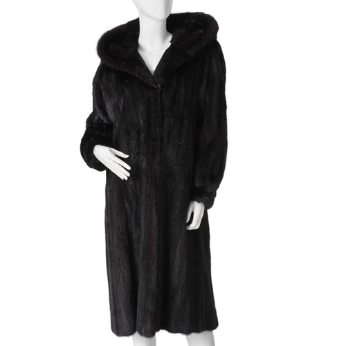 560 - A hooded dark ranch mink coat, designed with a large fur-lined hood, double hook and eye clip fasten... 