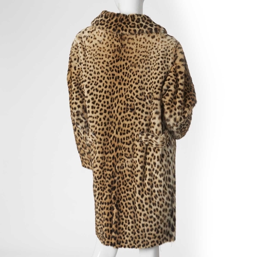 574 - A 1960s knee-length leopard fur coat, featuring a notched lapel collar, two outer pockets and two re... 