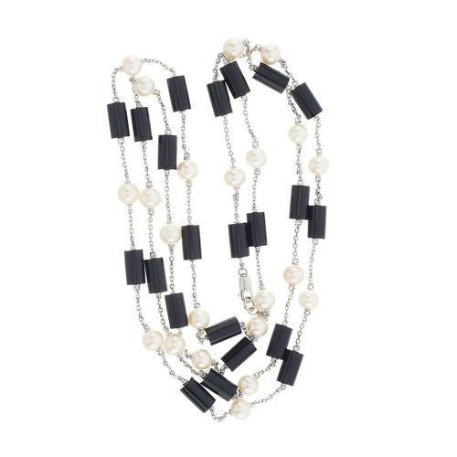 74 - A platinum alternating onyx and cultured pearl longuard necklace, pearls measure approximately 5.8mm... 