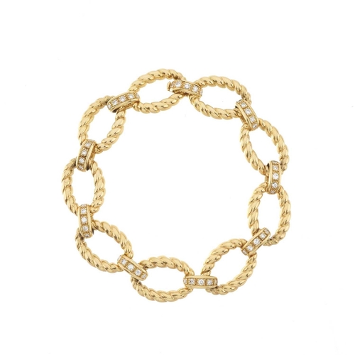 81 - A 1980s 18ct gold grooved-link bracelet, with diamond line spacers and folding clasp, estimated tota... 