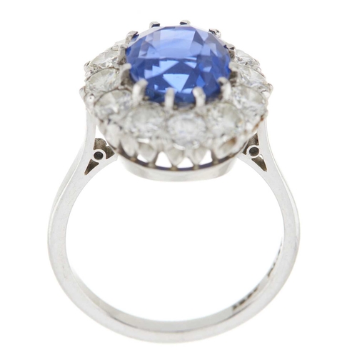 92 - An 18ct gold and platinum, Sri Lankan sapphire and brilliant-cut diamond cluster ring, with photocop... 