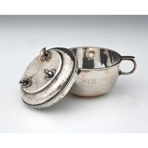 117 - A.E. Jones, an Arts and Crafts silver porringer and cover, Birmingham 1930, twin handled planished f... 