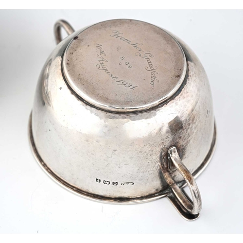 117 - A.E. Jones, an Arts and Crafts silver porringer and cover, Birmingham 1930, twin handled planished f... 