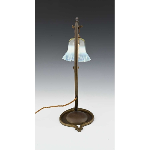 153 - W A S Benson, an Arts and Crafts brass table lamp, model 1079, circa 1900, strap arched arm on a fol... 