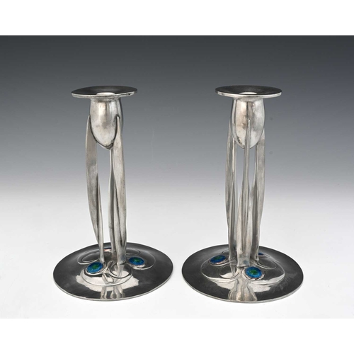 181 - Archibald Knox for Liberty and Co., a pair of Tudric Arts and Crafts pewter and enamelled candlestic... 